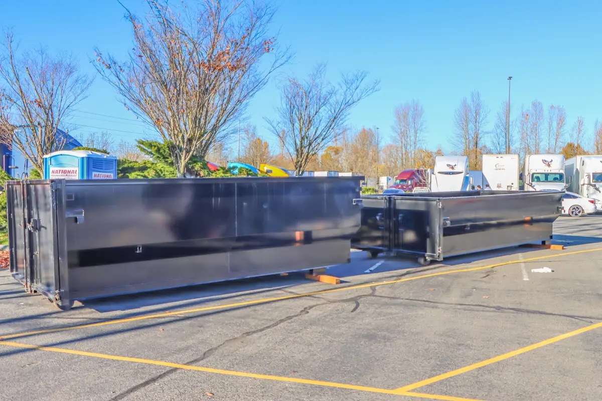 Professional dumpster rental service with roll-off container on residential driveway in Makakilo